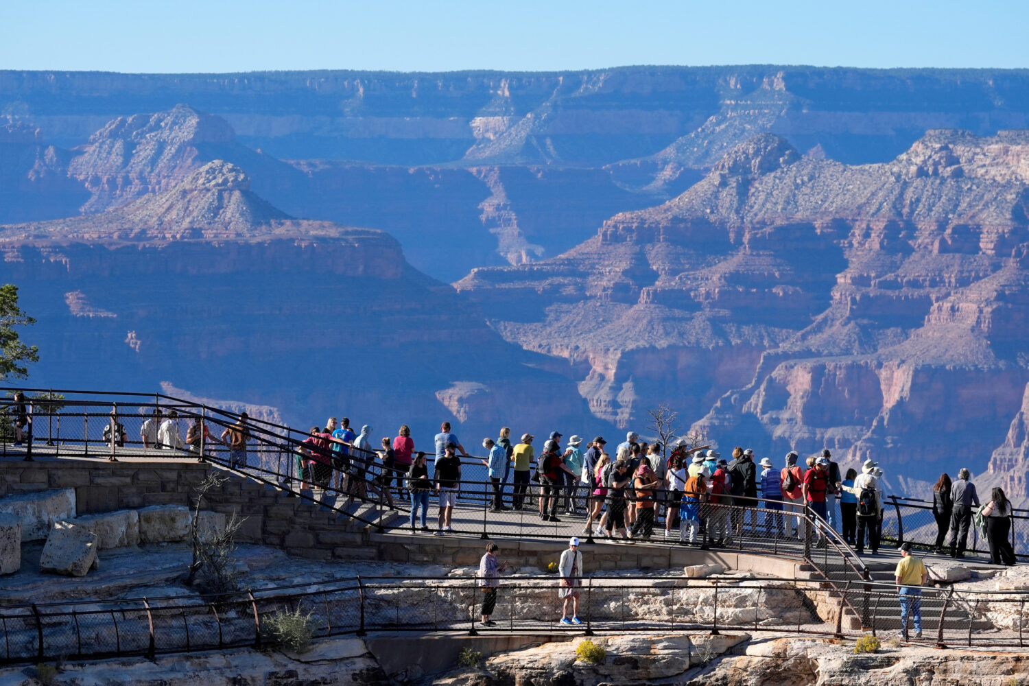 FILE - Tourists flock to Mather Point at Grand Canyon National Park, Oct. 1, 2025, in Grand Canyon,...