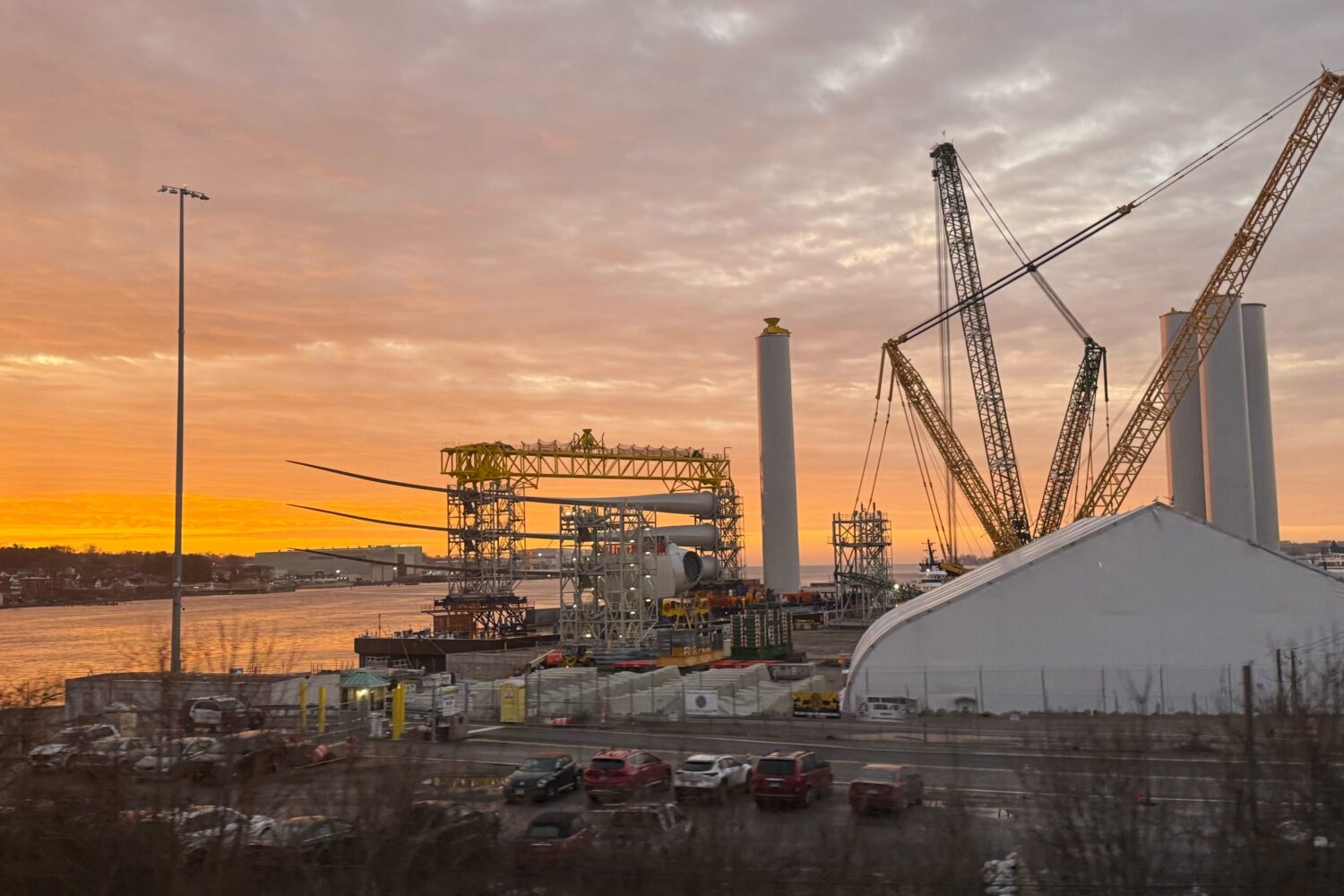 FILE - Blades and turbine bases for offshore wind sit at a staging area at New London State Pier, J...