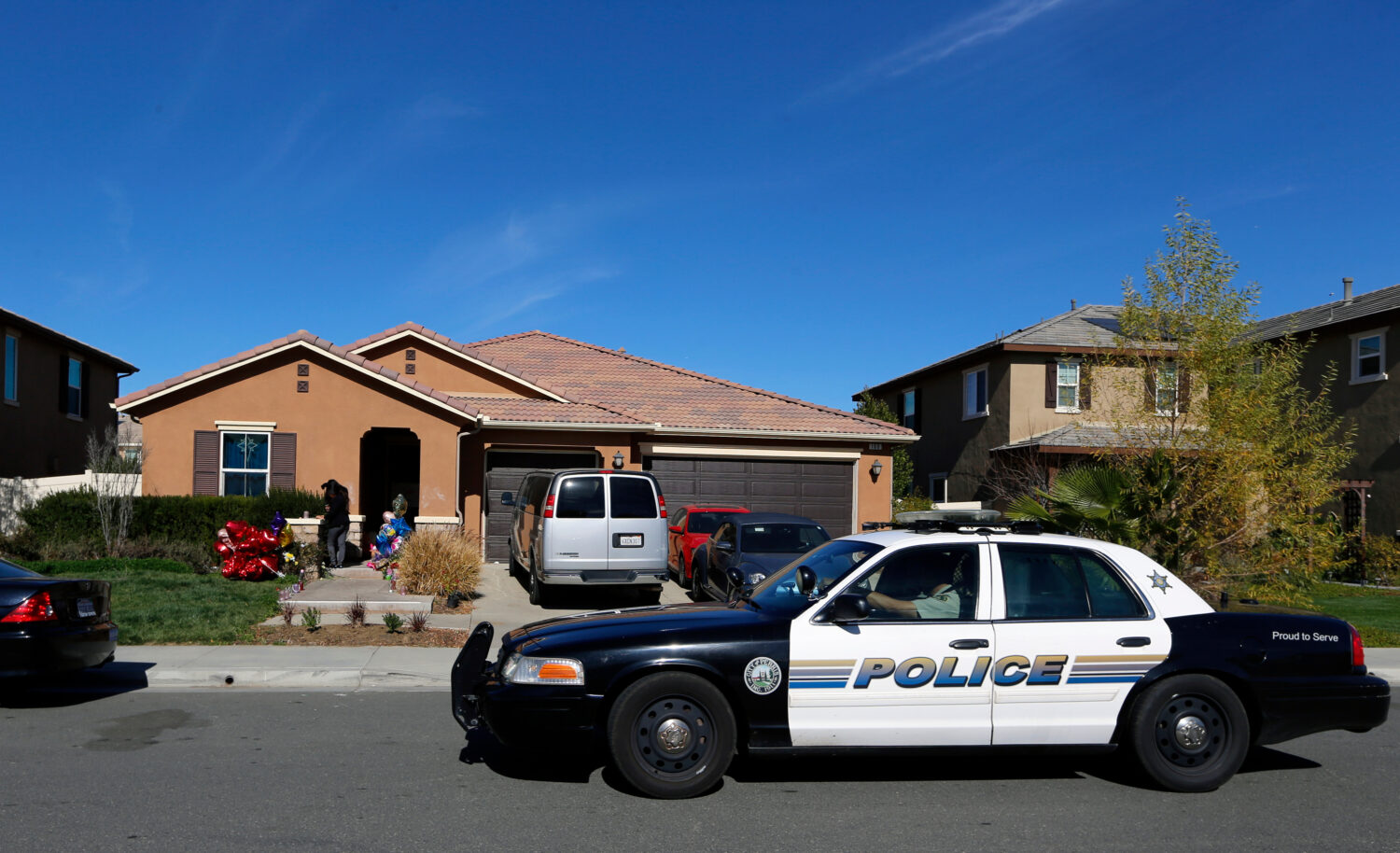 FILE - A police car drives past the home of David and Louise Turpin, where police arrested the coup...
