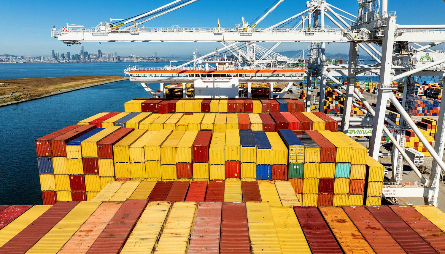 FILE - Cargo containers line a ship at the Port of Oakland on Wednesday, Aug. 6, 2025, in Oakland, ...