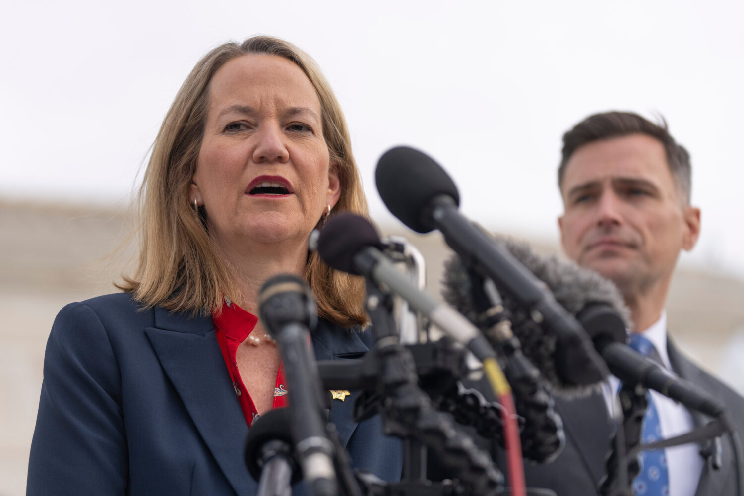 FILE - Arizona Attorney General Kris Mayes speaks to reporters as Oregon Attorney General Dan Rayfi...