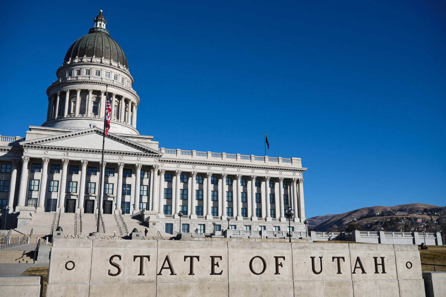 FILE - Flags fly at the Utah State Capitol, Jan. 18, 2026, in Salt Lake City. (AP Photo/Sydney Scha...