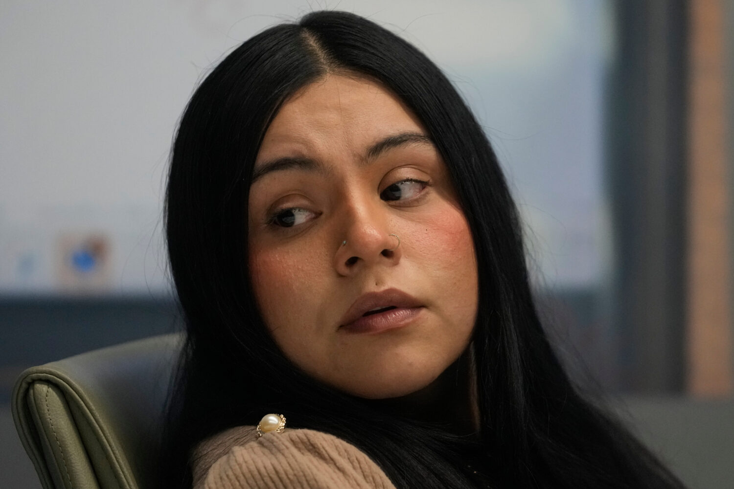 Marimar Martinez, a woman who was shot by a Border Patrol agent last year, sits with her attorneys ...