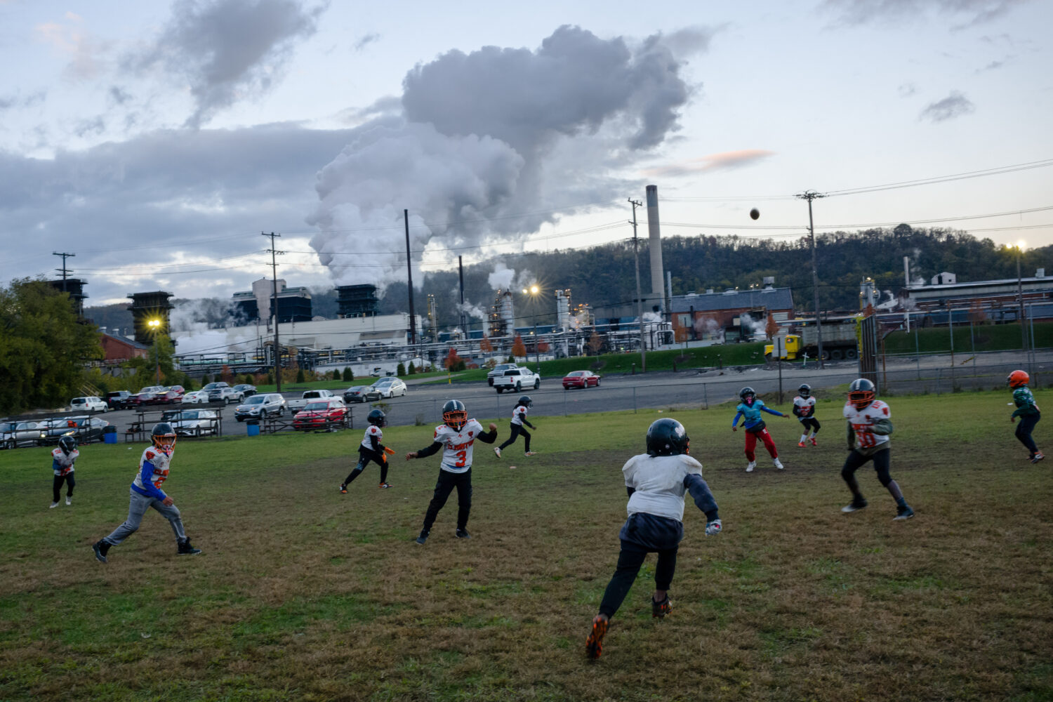 Youth football players practice near U.S. Steel's Clairton Coke Works in Clairton, Pa., on Thursday...