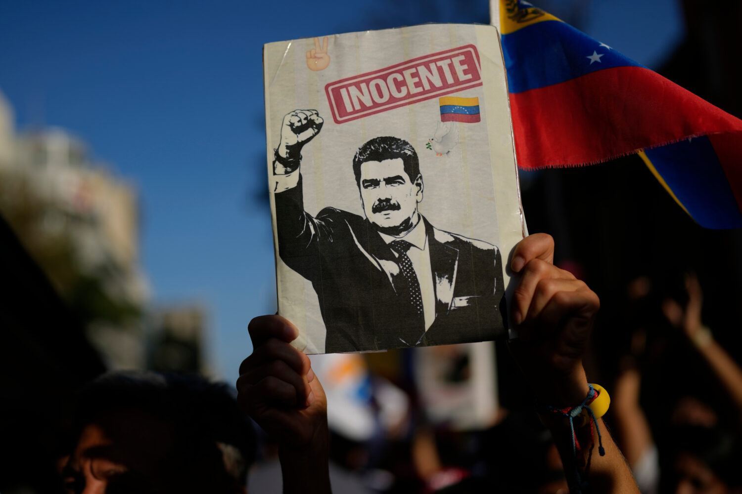 A government supporter holds an image of former President Nicolás Maduro during a march calling fo...