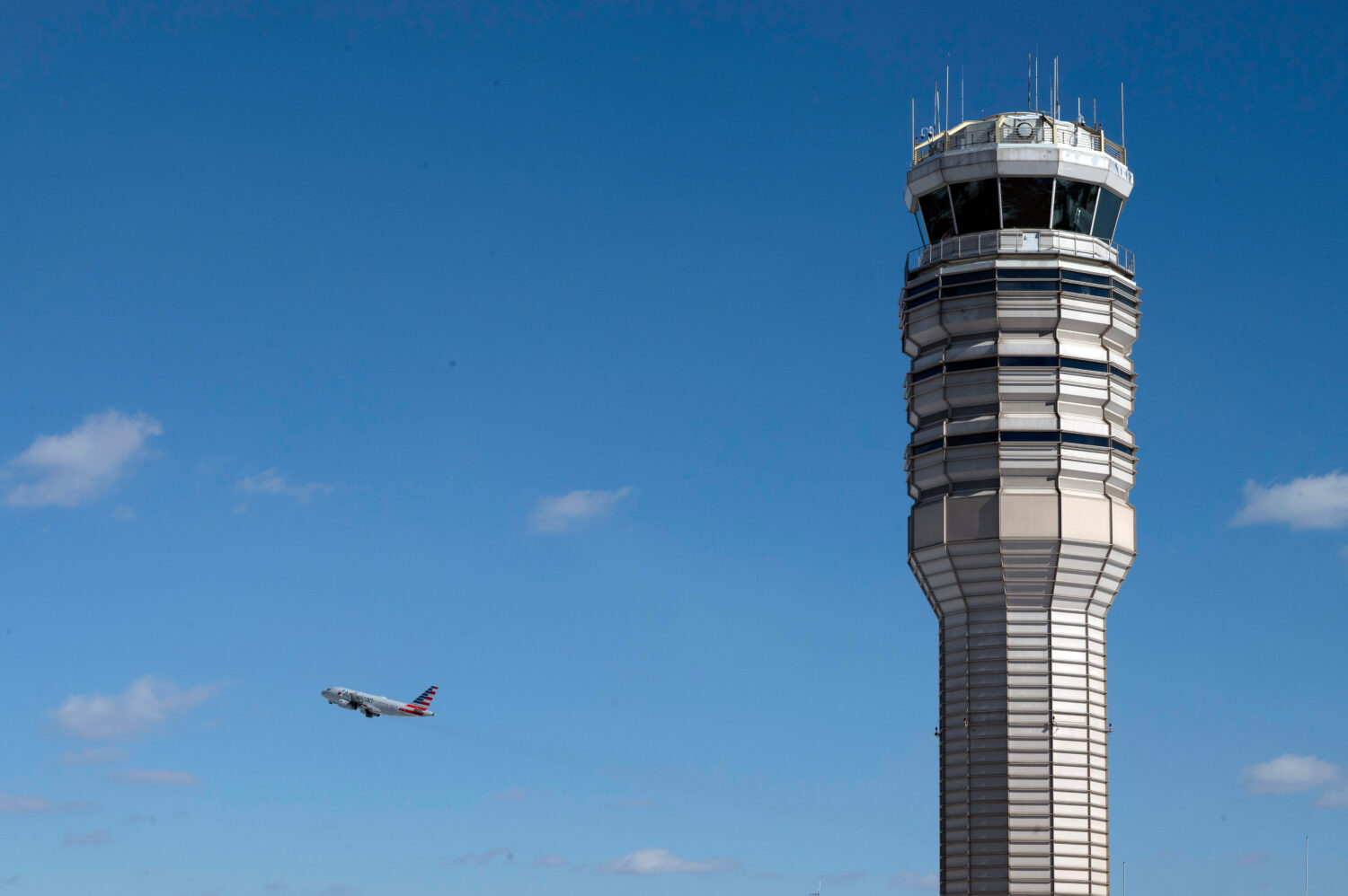 An airplane takes off behind the control tower at Ronald Reagan Washington National Airport, on the...