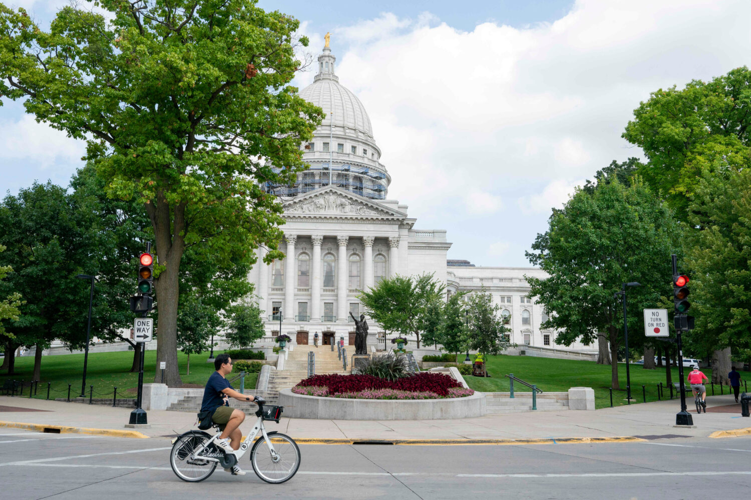 FILE - A cyclist rides past the Wisconsin State Capitol July 30, 2024, in Madison, Wis. (AP Photo/K...
