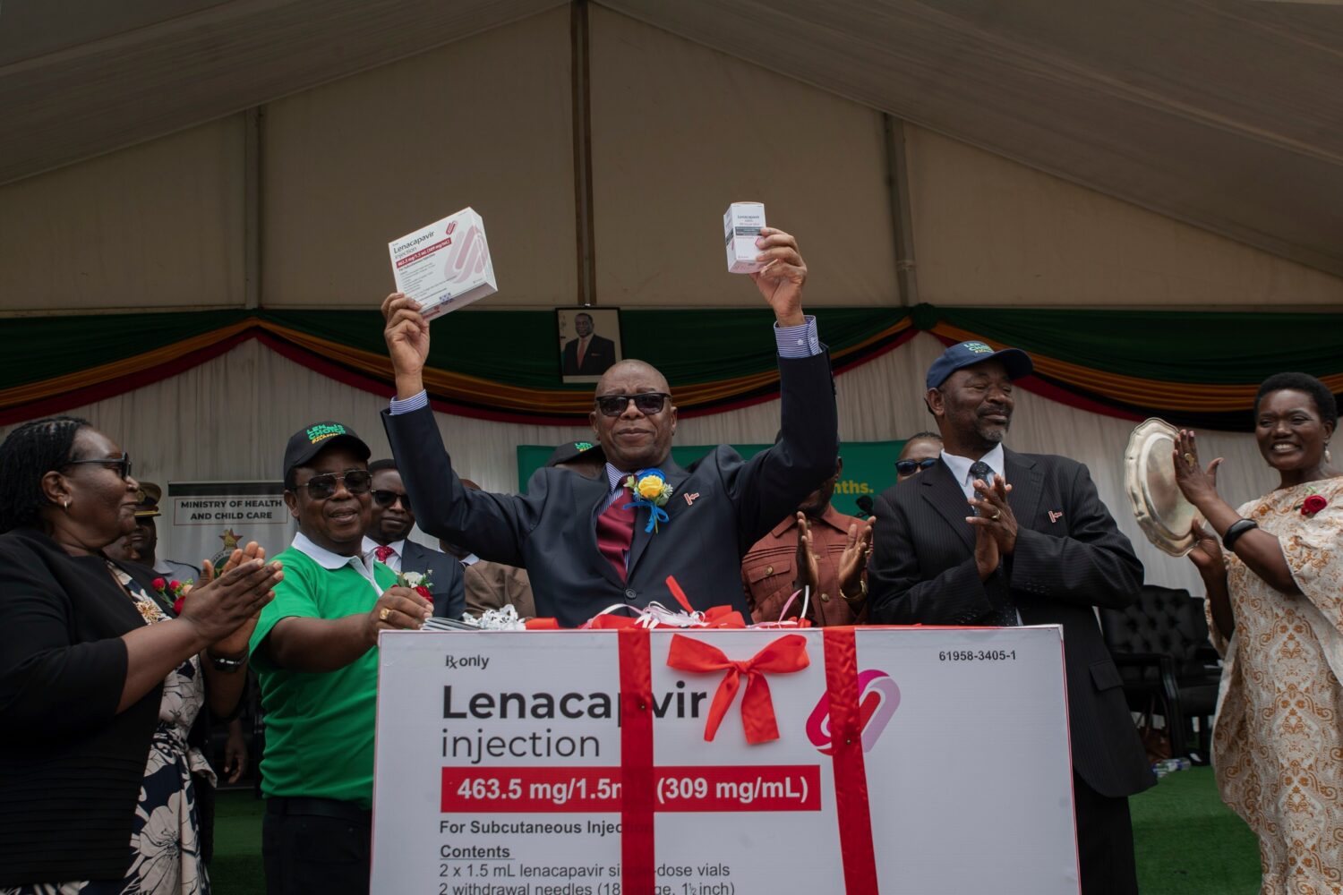 FILE - Zimbabwe's Minister of Health and Child Care Douglas Mombeshora holds up containers of lenac...