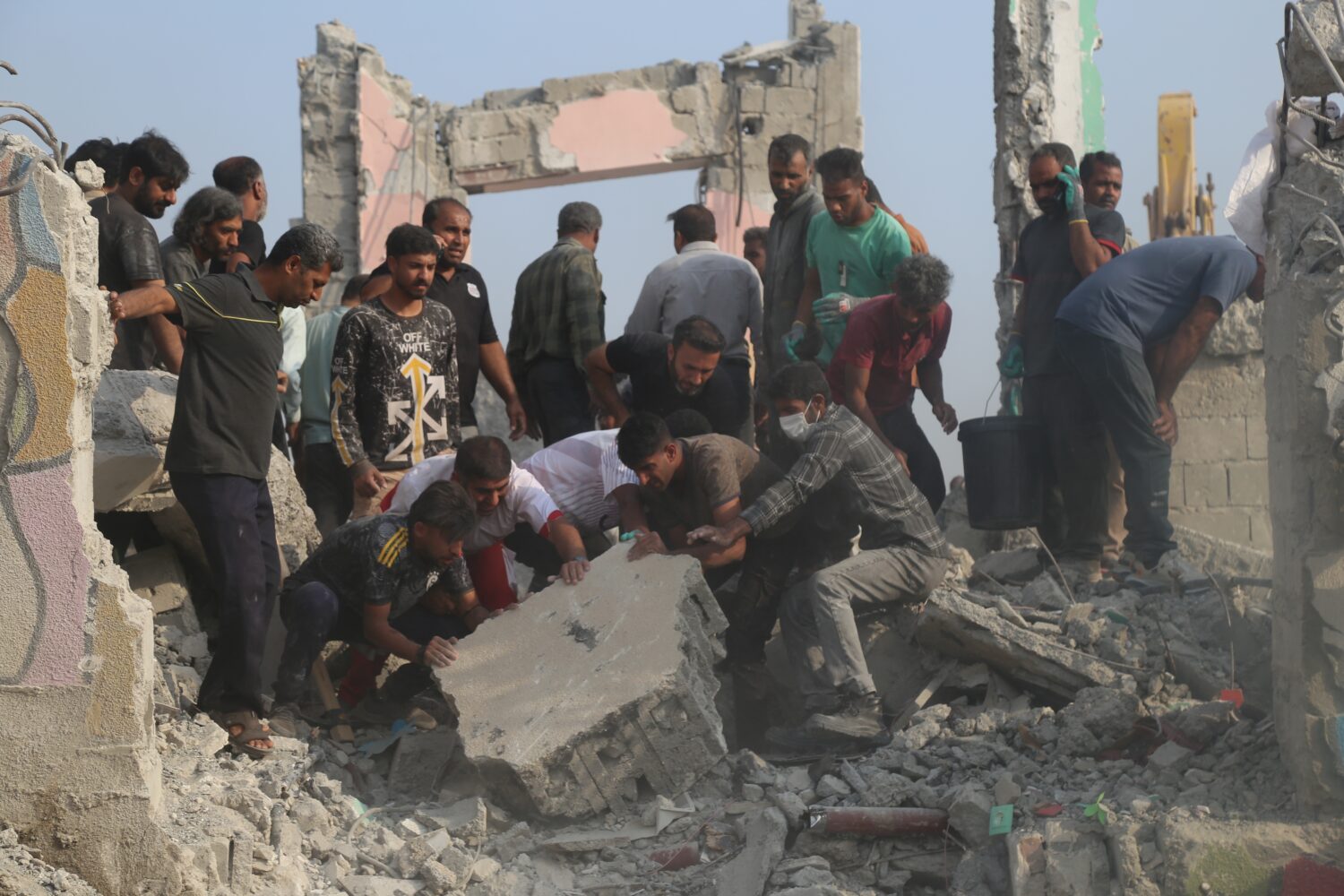 Rescue workers and residents search through the rubble in the aftermath of what Iranian officials s...