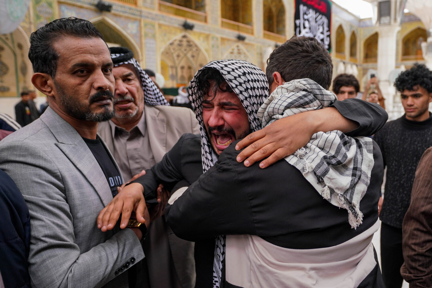 Relatives grieve an Iraqi soldier killed in a strike Wednesday on a military clinic in western Iraq...