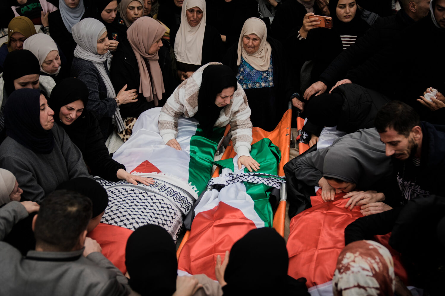 Palestinians mourn at the funeral of four members of the Odeh family who were killed in their car b...