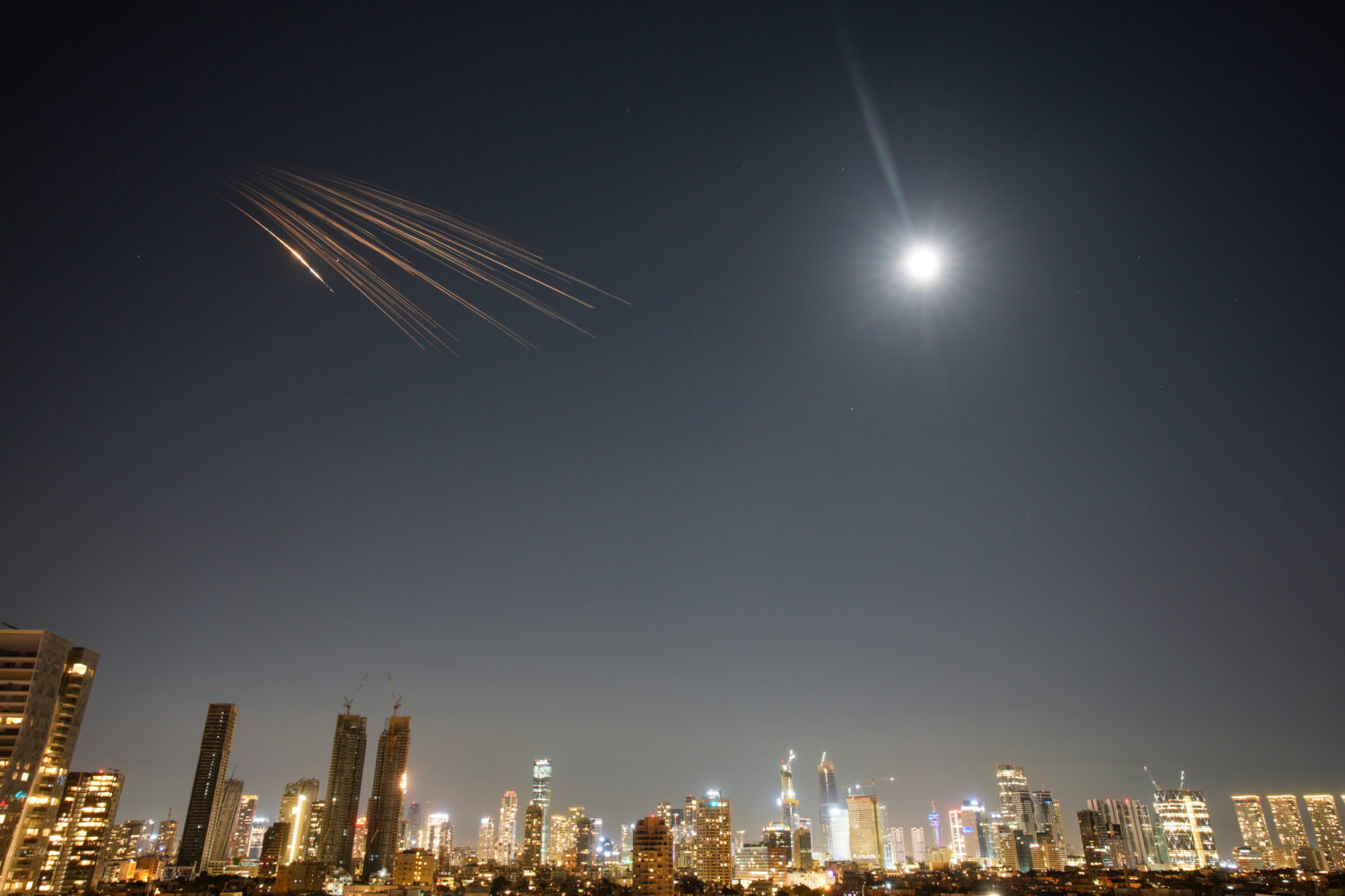Missiles launched from Iran are seen in the sky over central Israel, Thursday, March 5, 2026. (AP P...