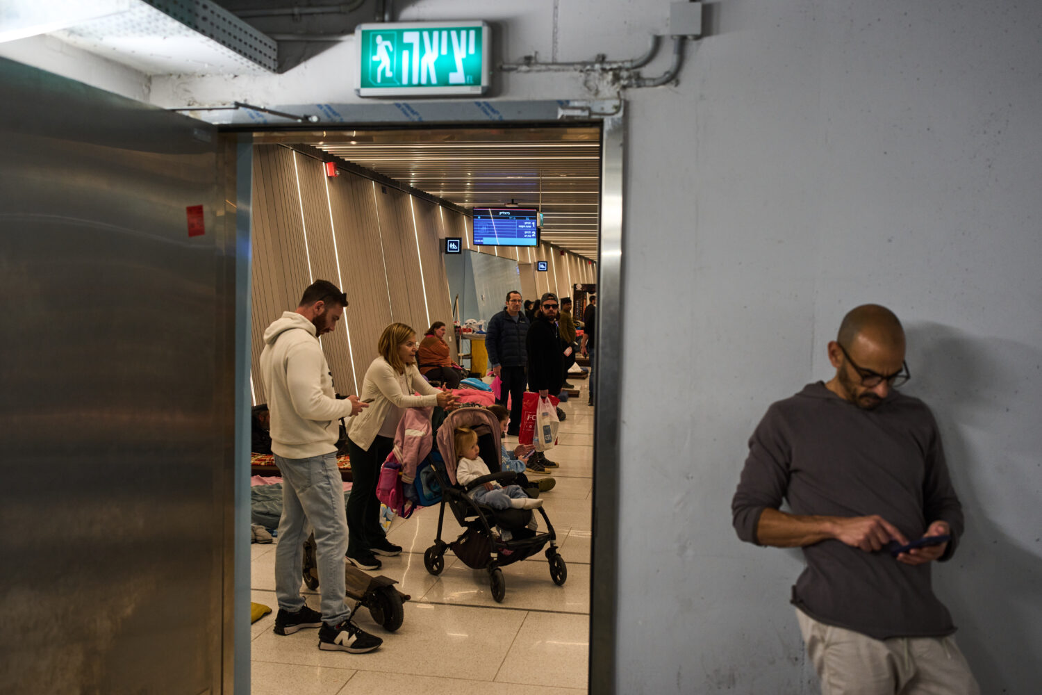 People take shelter in an underground metro station as air raid sirens warn of incoming Iranian mis...