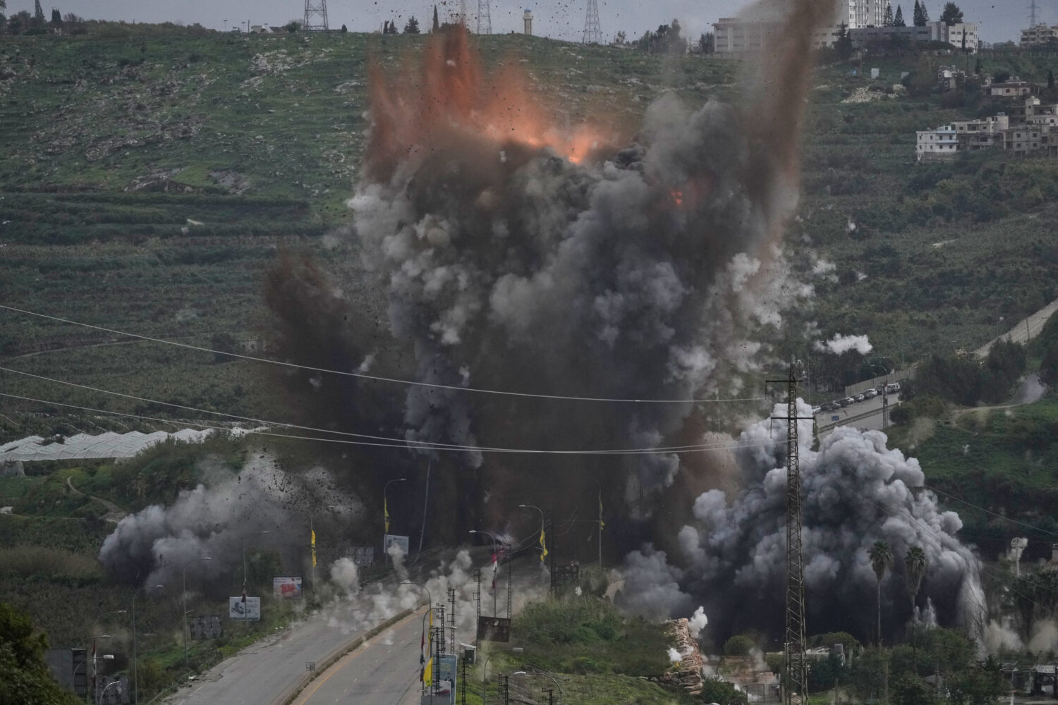 Smoke and flames rise from an Israeli airstrike that hit the Qasmiyeh Bridge near the coastal city ...