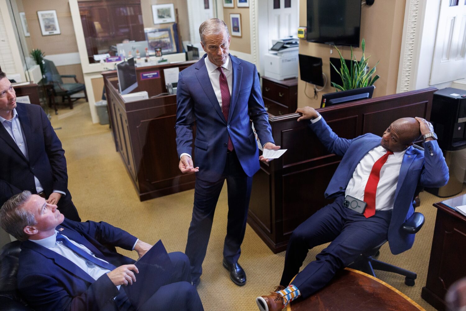 Senate Majority Leader John Thune R-S.D., center, privately speaks to Sen. Jon Husted, R-Ohio, and ...