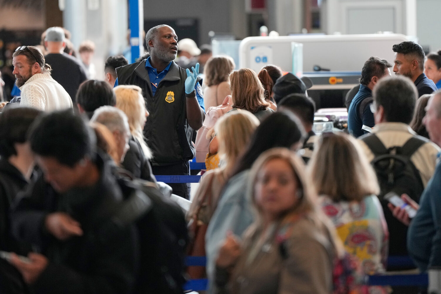Passengers are directed through a security checkpoint line at George Bush Intercontinental Airport ...