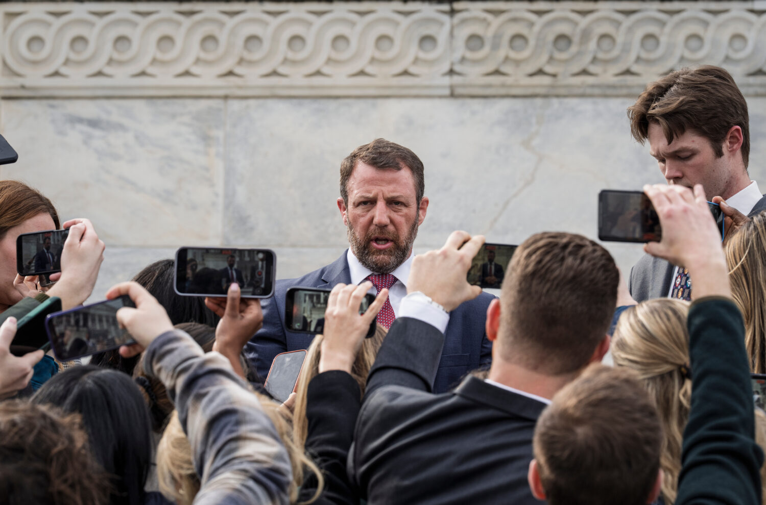 Sen. Markwayne Mullin, R-Okla., speaks with reporters on the steps at the Capitol in Washington, Th...