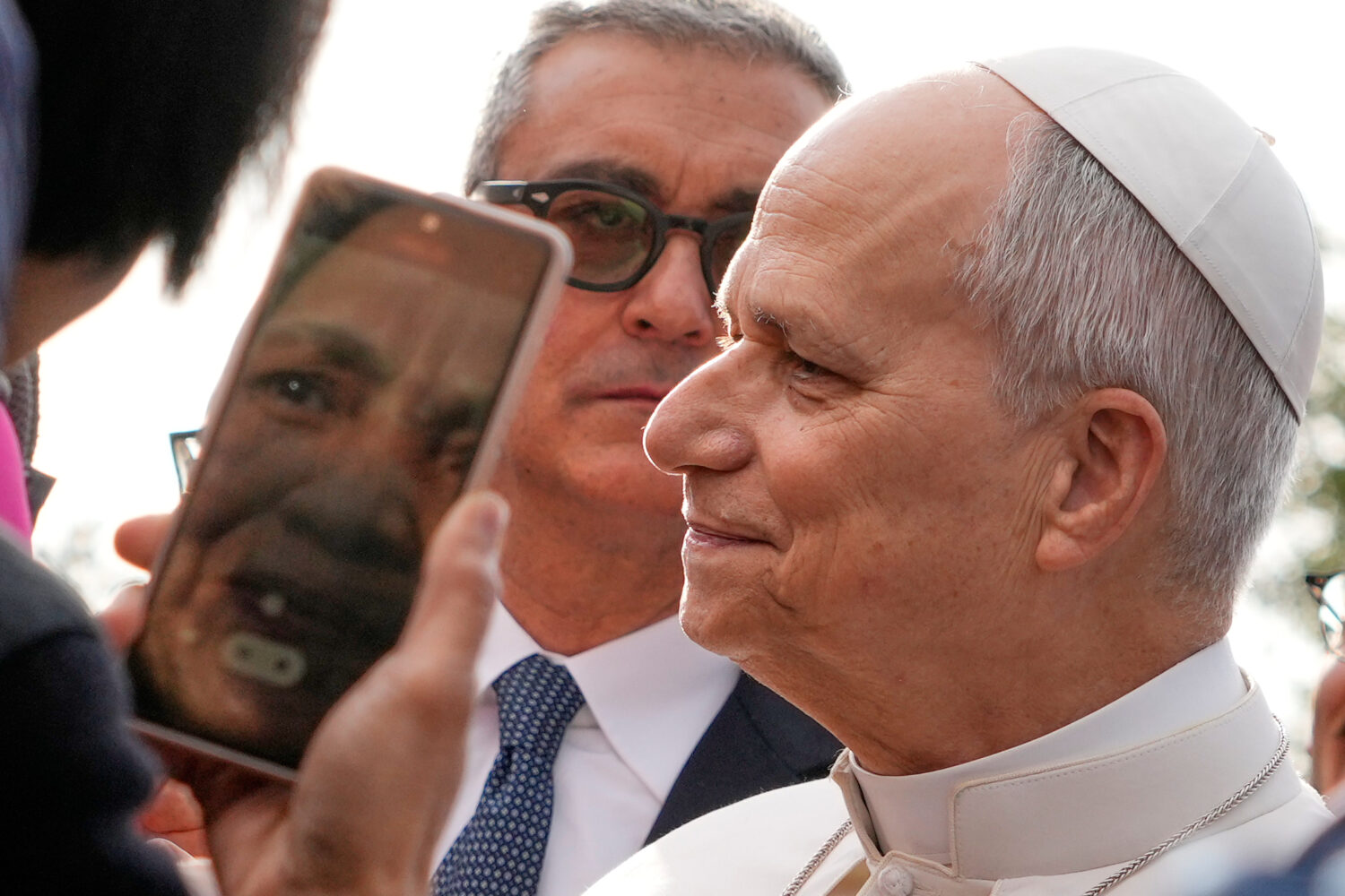 The head of Vatican Security, Gianluca Gauzzi Broccoletti, center, follows Pope Leo XIV as he visit...