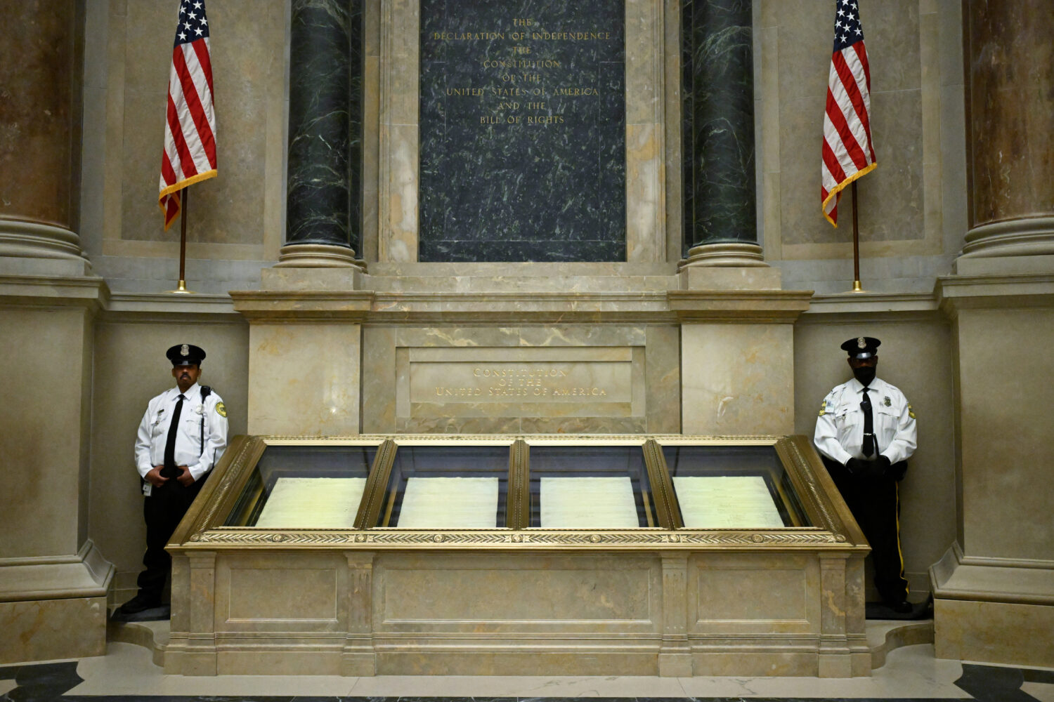 FILE - Two guards stand their posts at the cases containing the United States Constitution at the N...