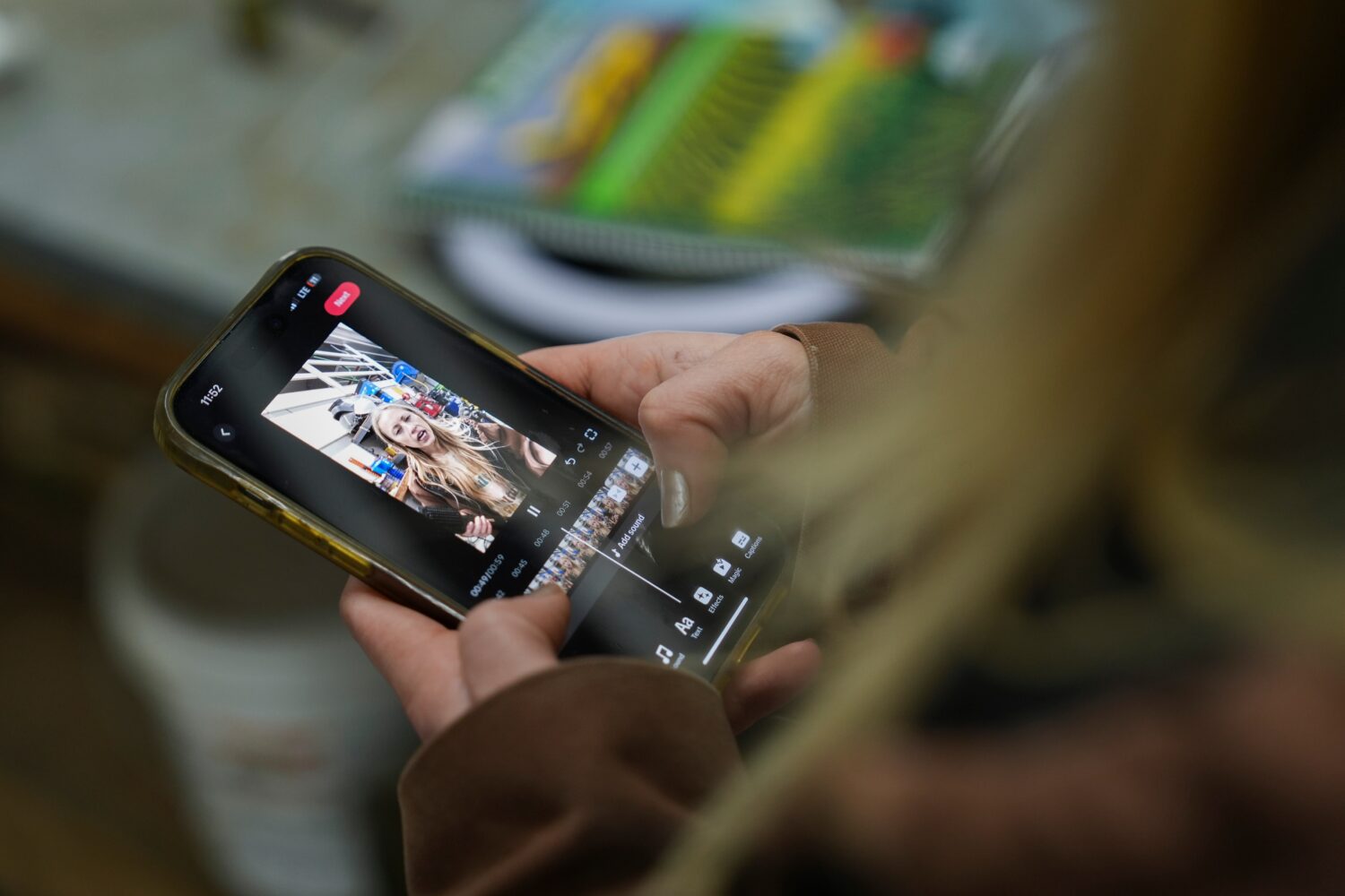 FILE - Zoe Kent edits a social media video on the TikTok app, Jan. 20, 2025, at her farm in Bucyrus...