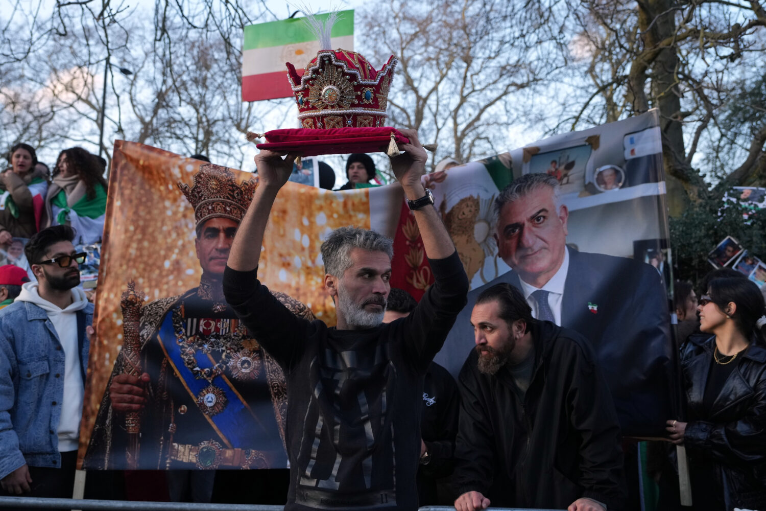 A protester holds a crown in London, Saturday, Feb. 28, 2026 after U.S. and Israeli forces carried ...