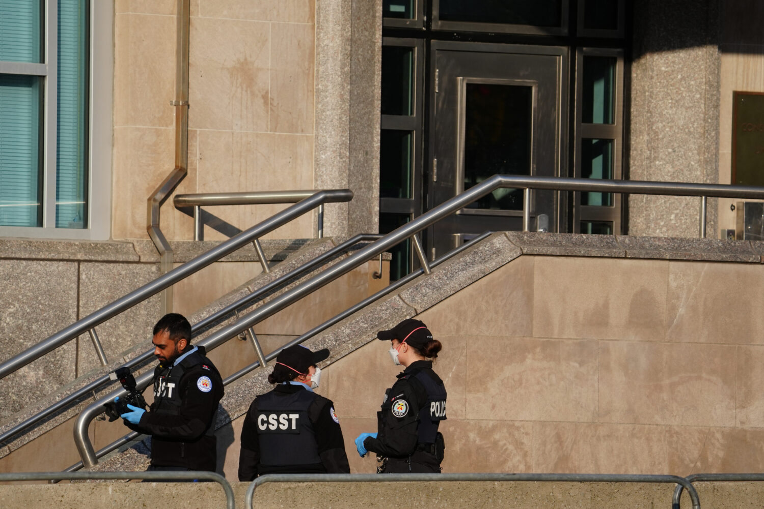 Toronto police investigate the scene after the U.S. consulate was hit by gunfire in Toronto on Tues...