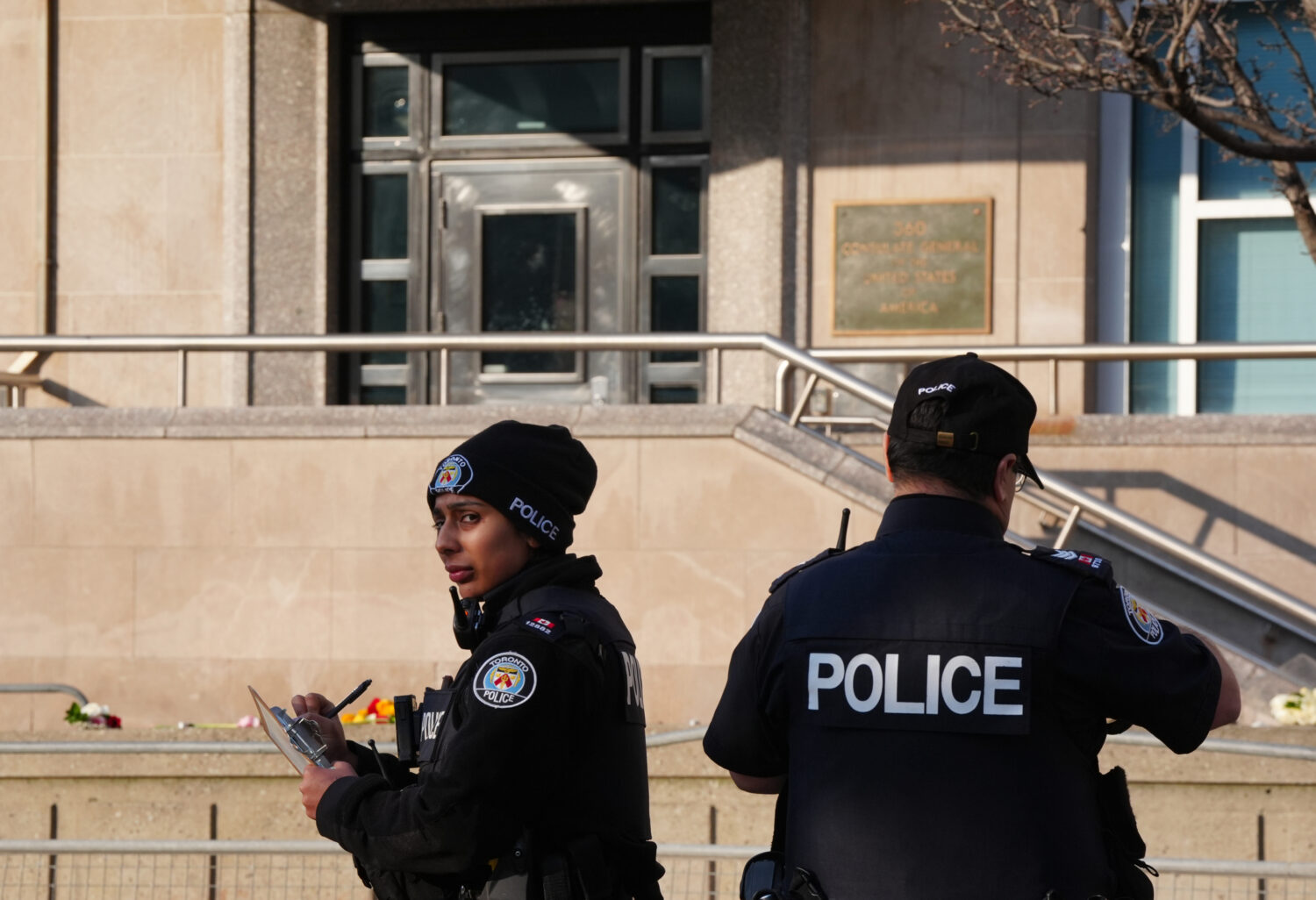 Toronto police investigate the scene after the U.S. consulate was hit by gunfire in Toronto on Tues...