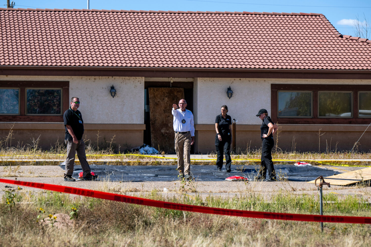 FILE - Fremont County coroner Randy Keller, center, and other authorities survey the area where the...