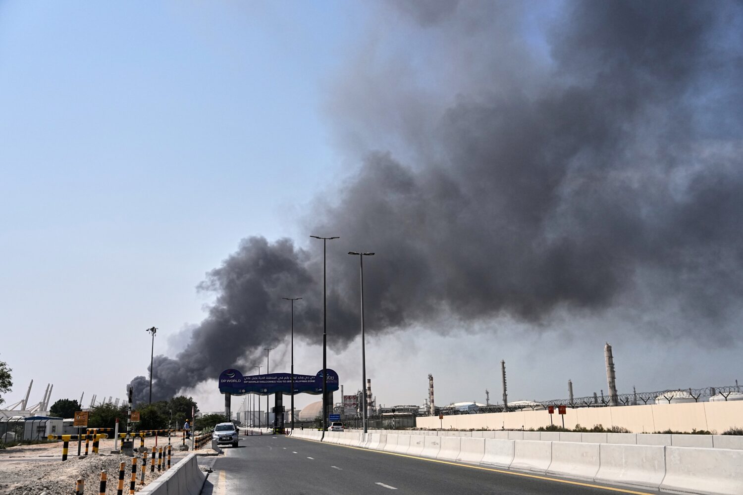 Smoke rises after an Iranian drone attack in the port area of Dubai, United Arab Emirates, Sunday, ...