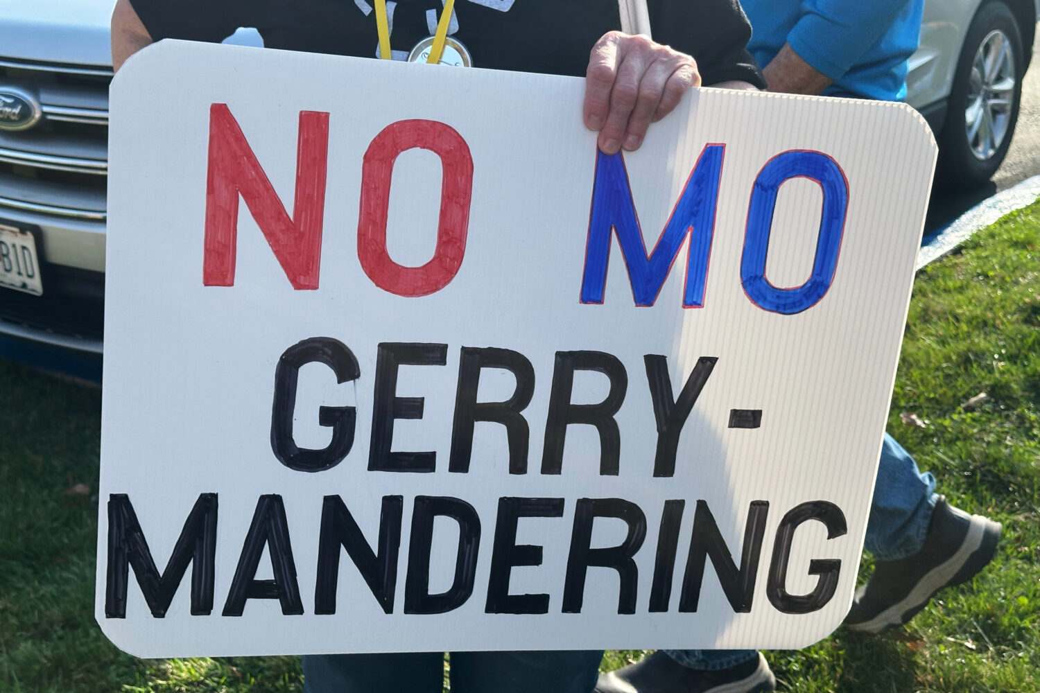 A person holds a sign opposing the new U.S. House districts passed by the Missouri General Assembly...