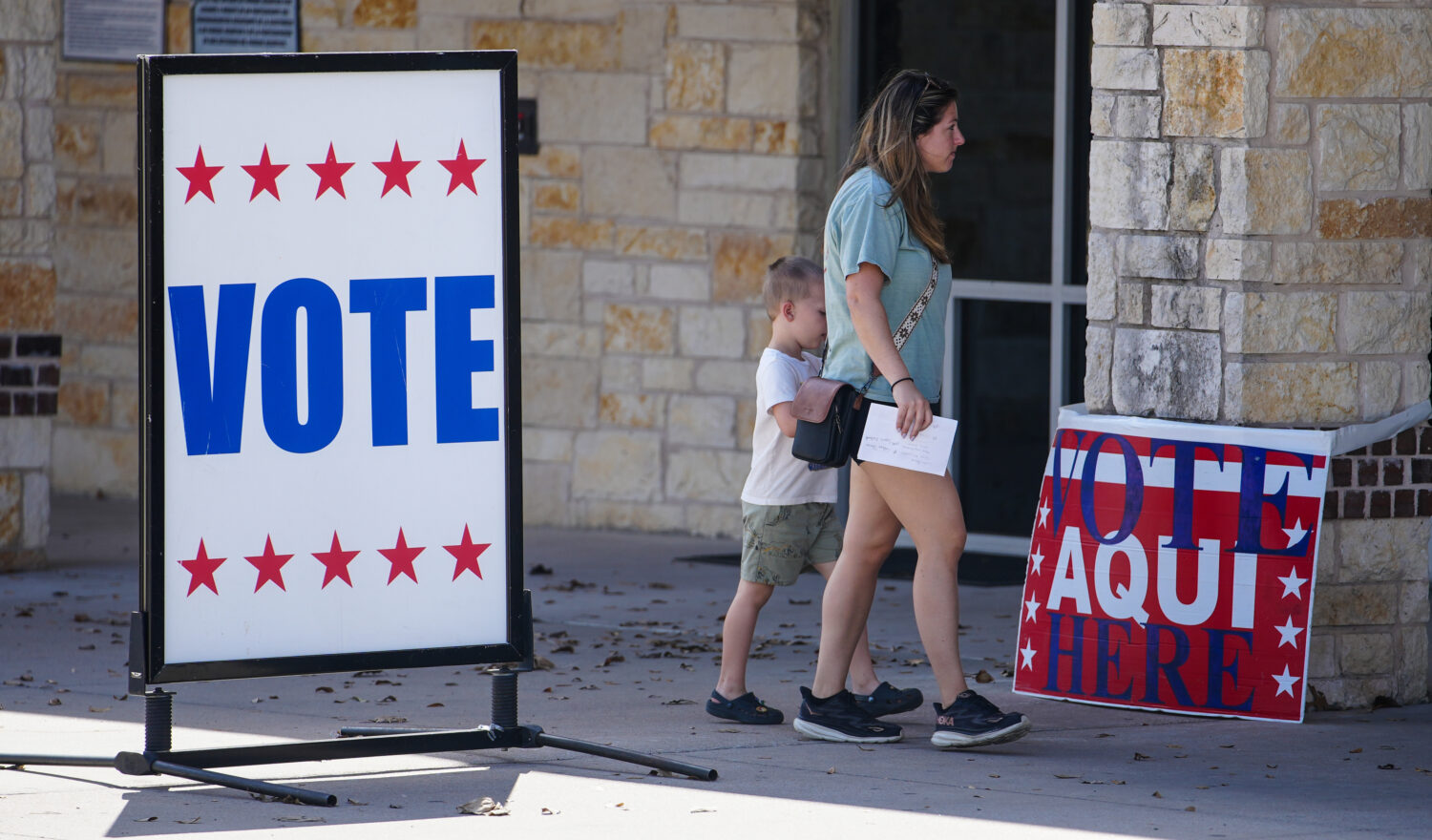 Voters in central Texas make their way to an active polling station to vote in Pflugerville, Texas,...
