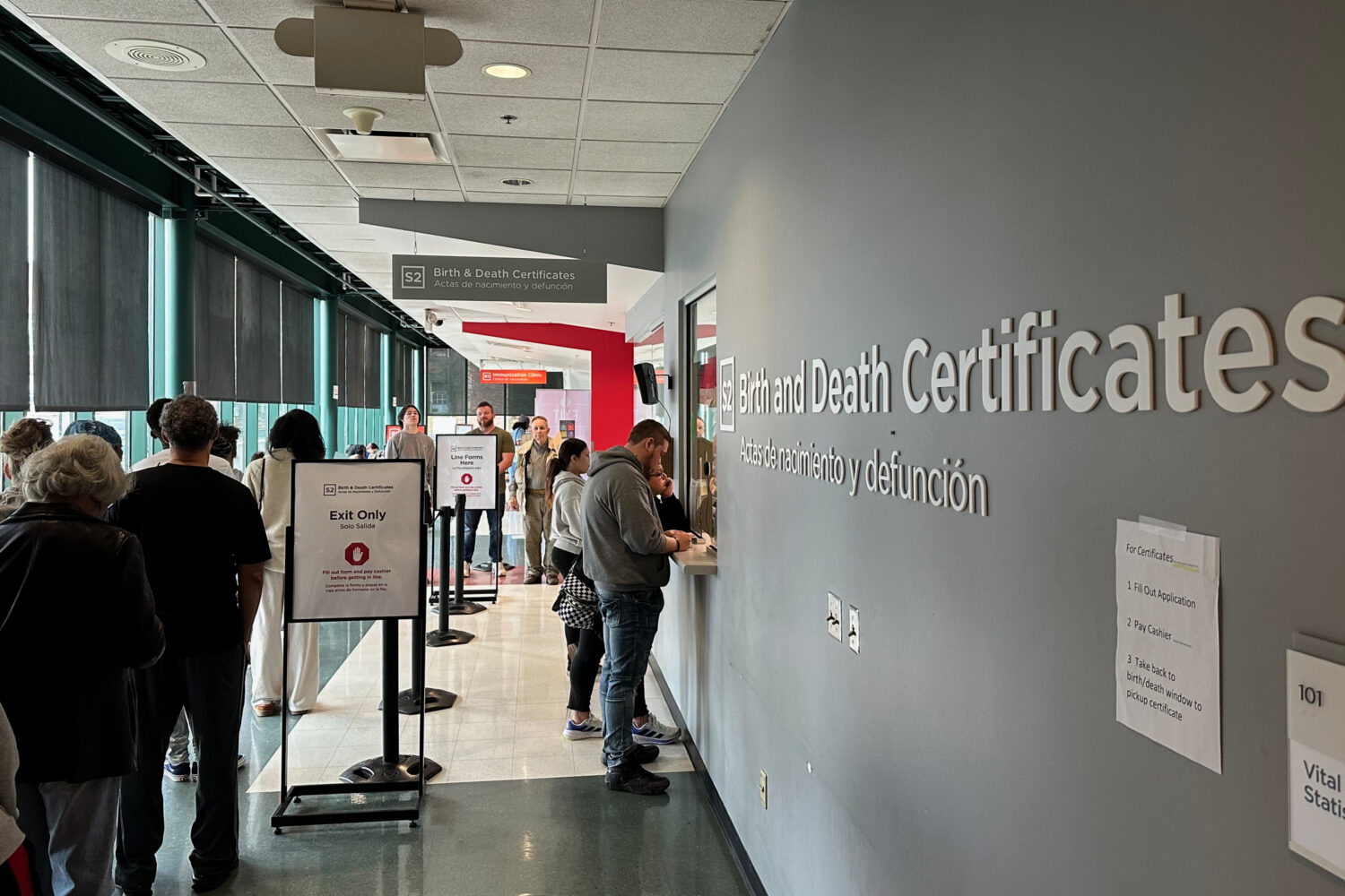 Customers stand in line to get birth and death certificates at the Columbus Public Health Departmen...