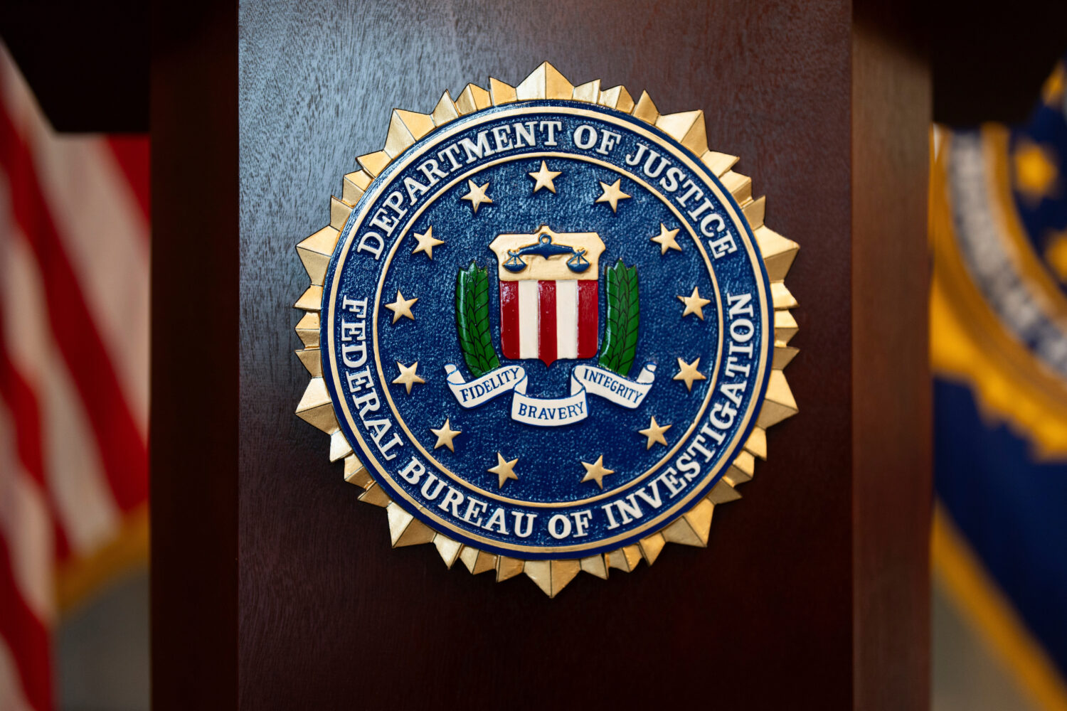 FILE - An FBI seal is displayed on a podium before a news conference at the field office in Portlan...