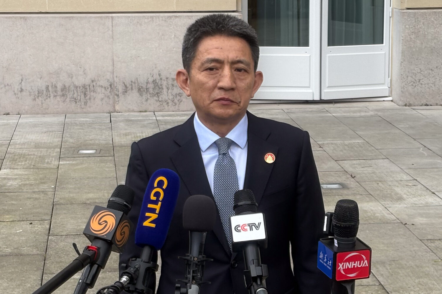 Chinese lead trade negotiator Li Chenggang gives a press conference at the Organization for Economi...