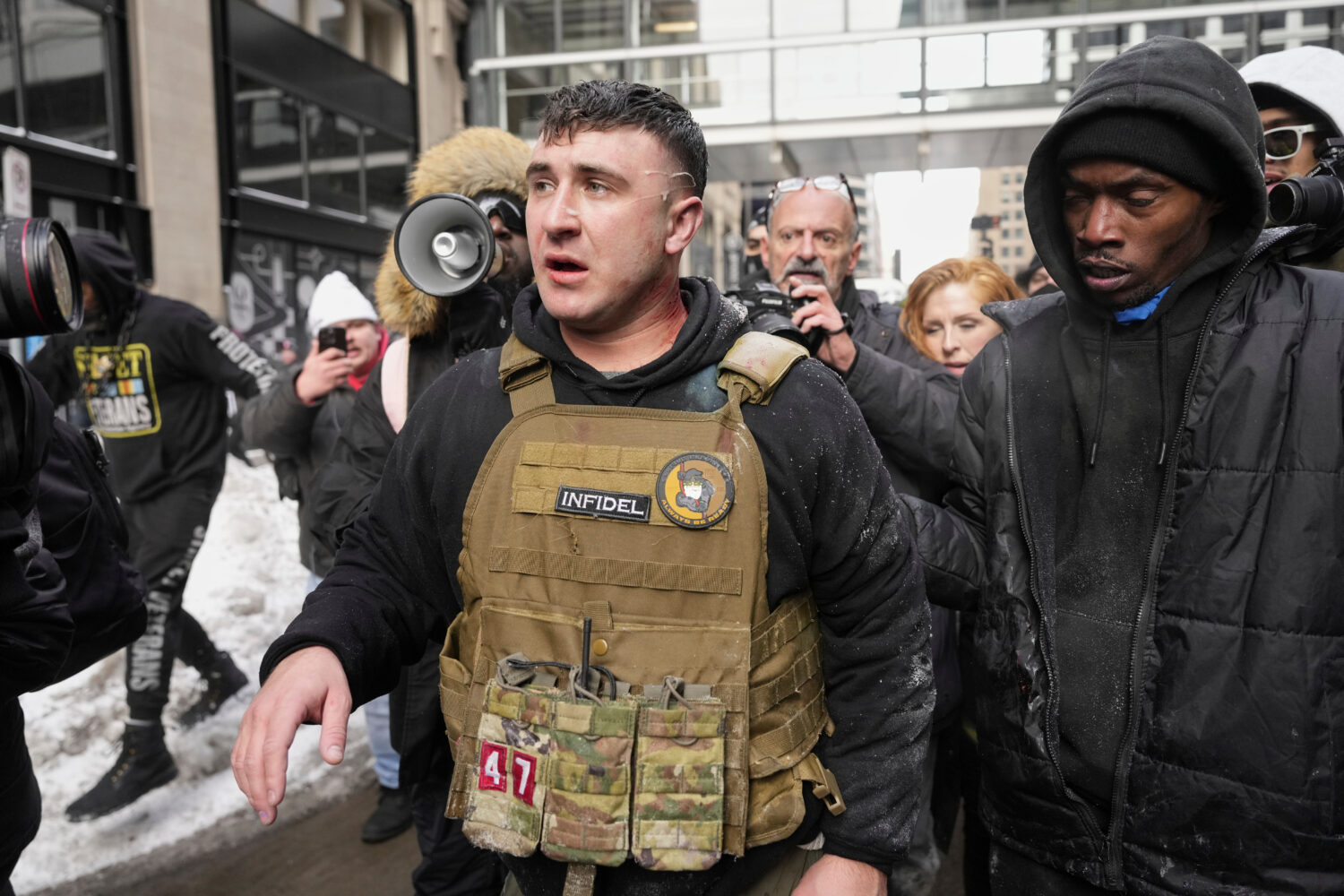 FILE - Jake Lang, center, walks away from counter protesters after an altercation near Minneapolis ...