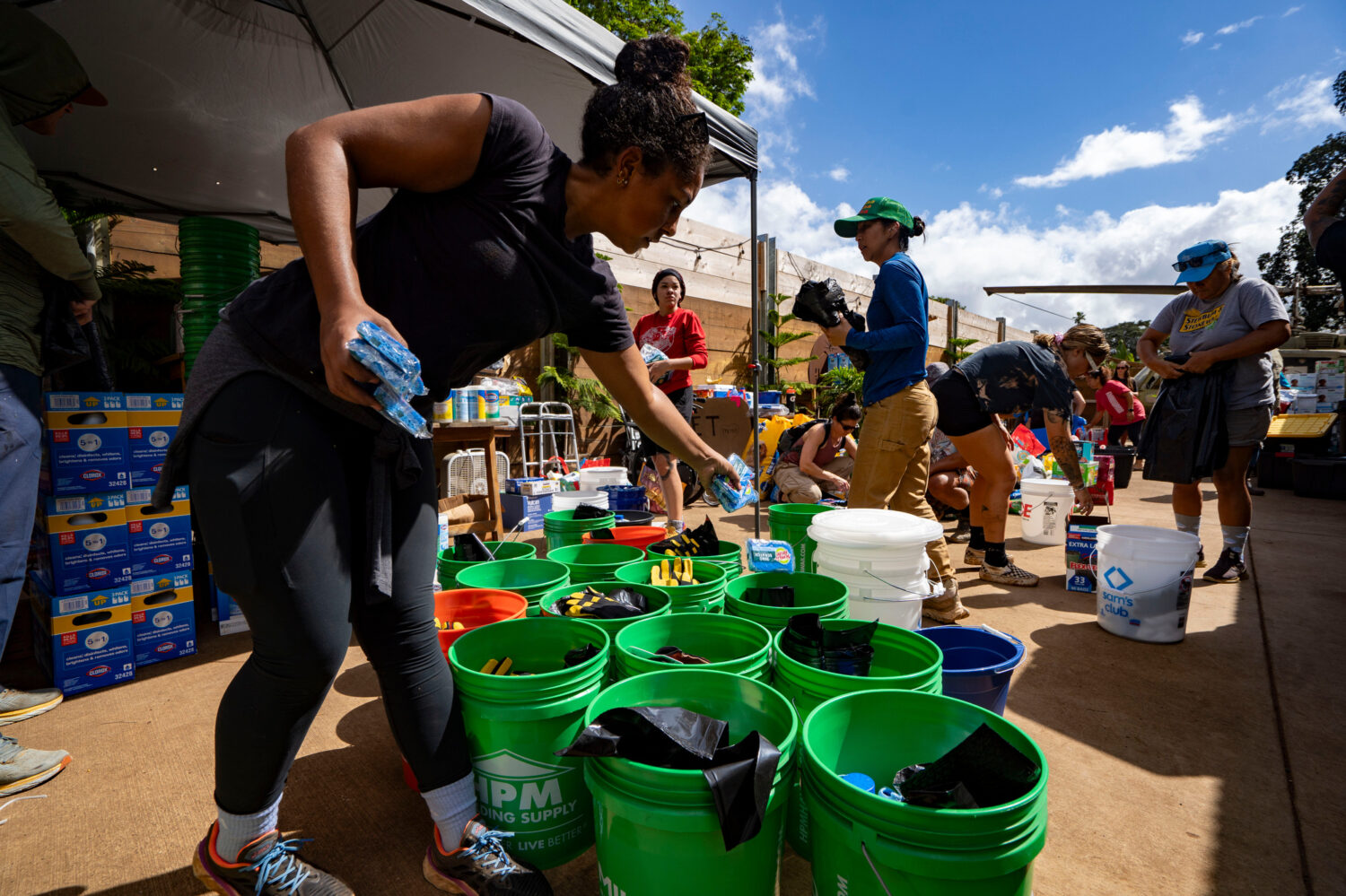 Volunteers sort donated supplies for distribution at Haleiwa Distillery following recent flooding, ...