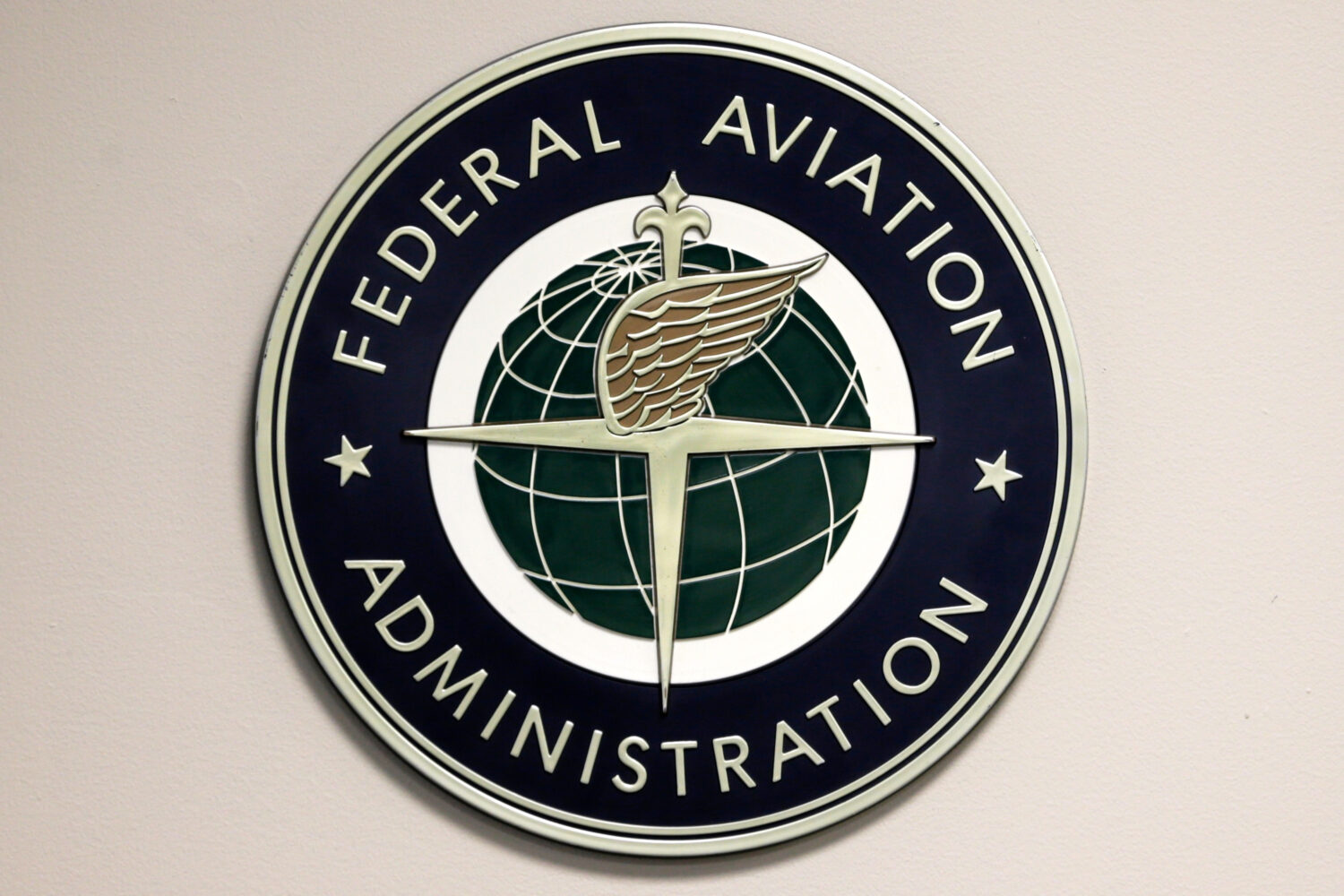 FILE - A Federal Aviation Administration logo is displayed in the tower at John F. Kennedy Internat...