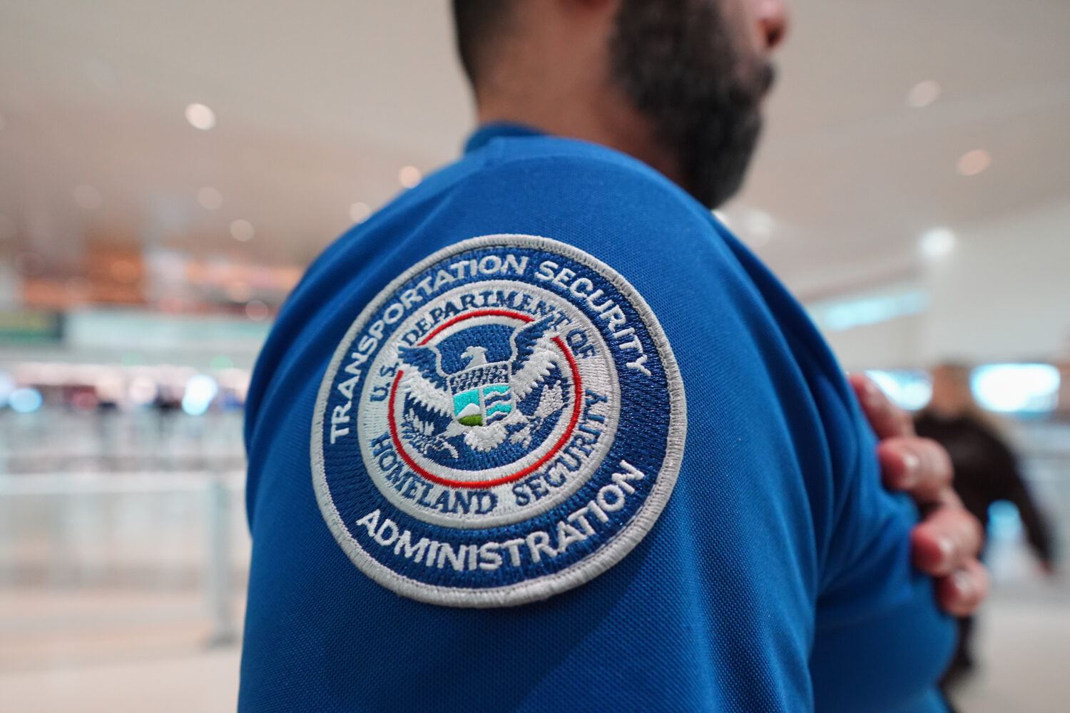A TSA agent wears a U.S. Department of Homeland Security patch on their uniform at Love Field Airpo...