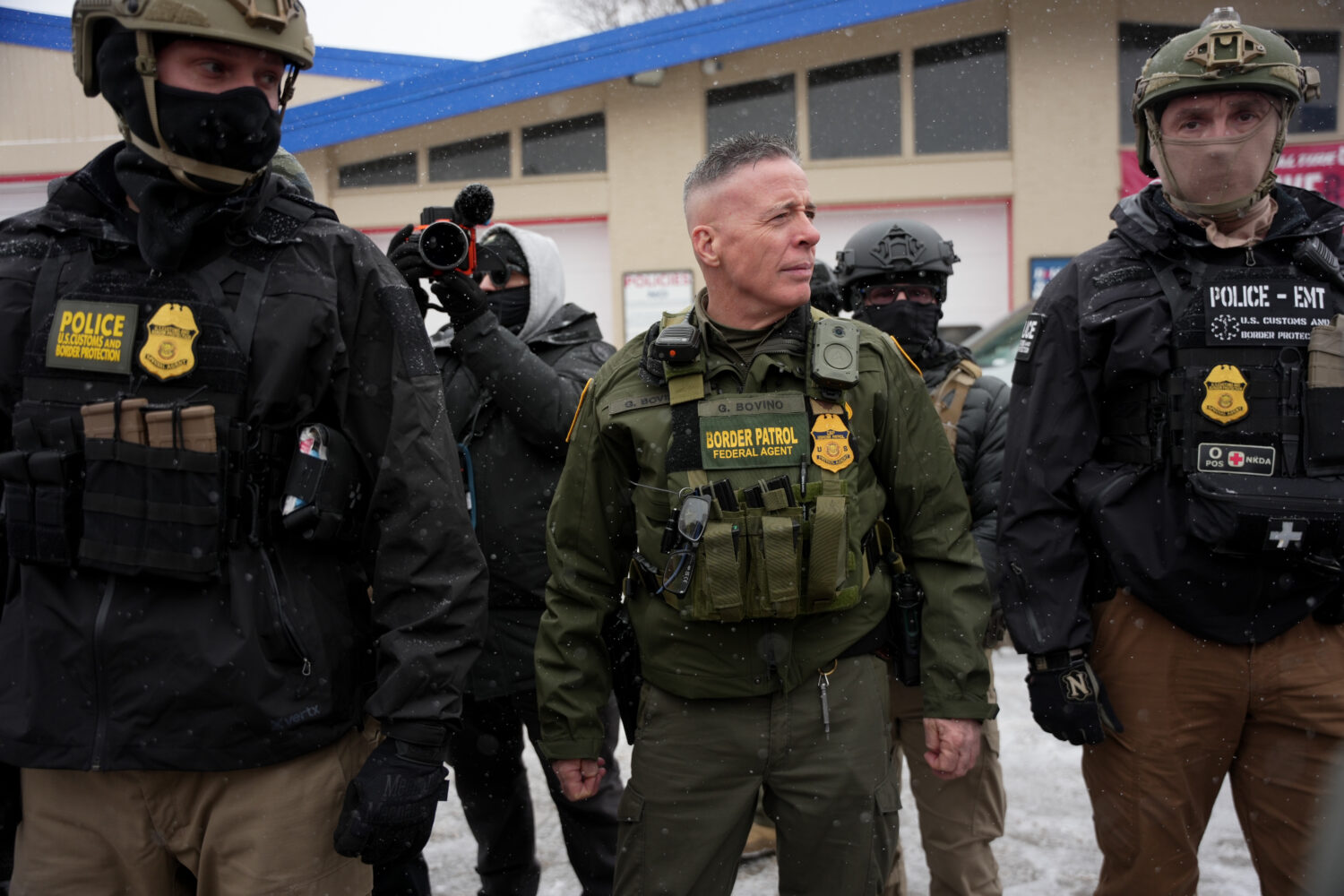 FILE - U.S. Border Patrol Cmdr. Gregory Bovino walks with federal agents outside a convenience stor...