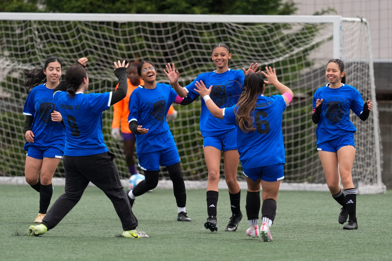 Aubrey Decraig, third from right, celebrates with teammates after scoring a goal during a soccer to...