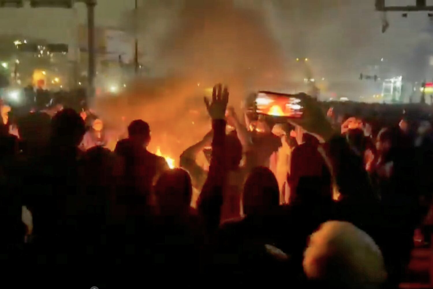 FILE - In this image from video circulating on social media, protesters dance and cheer around a bo...