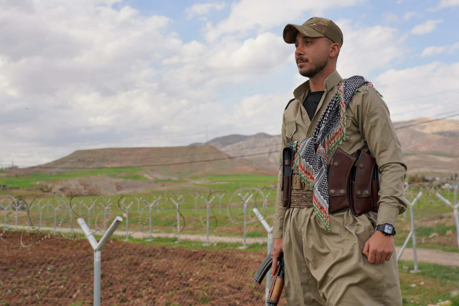 Member of the Democratic Party of Iranian Kurdistan PDKI stands at a checkpoint leading to their ba...