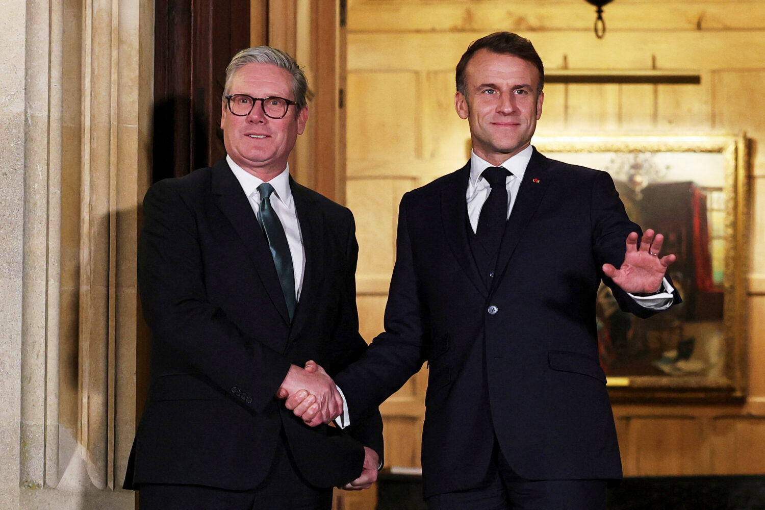 FILE - British Prime Minister Keir Starmer, left, and French President Emmanuel Macron shake hands ...
