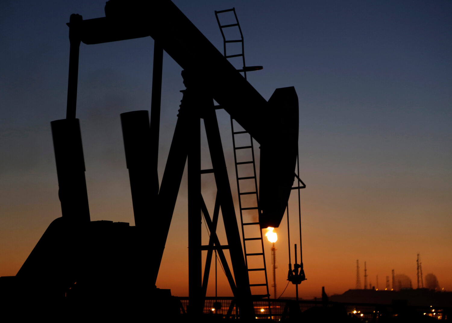 FILE - In this Jan. 18, 2016 file photo, an oil pump works at sunset, in the desert oil fields of S...