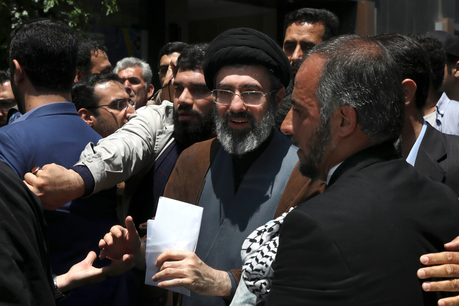 FILE - Mojtaba Khamenei, the son of Iranian Supreme Leader Ayatollah Ali Khamenei, center, attends ...