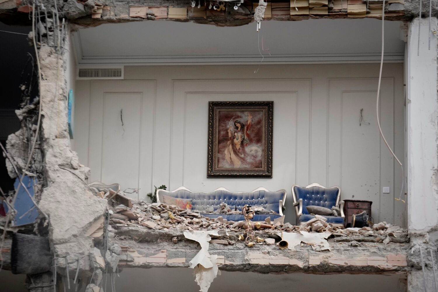FILE - Rubble covers the furniture of a destroyed living room in a residential building hit in an e...