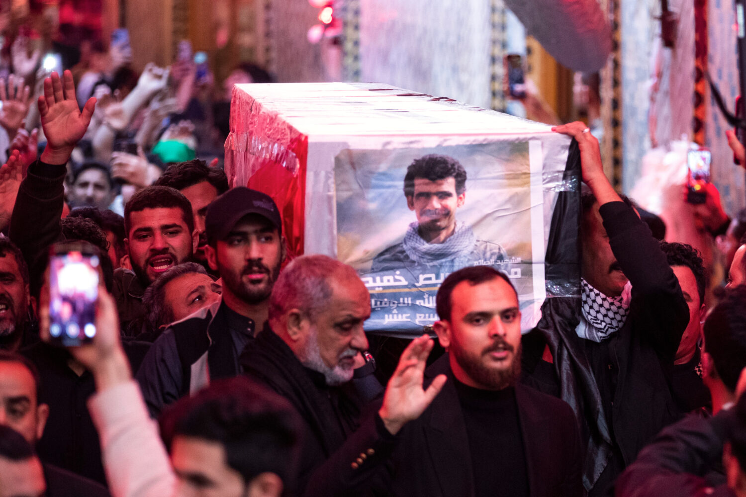 Members of the Popular Mobilization Forces attend a funeral in Najaf, Iraq, Friday, March 13, 2026 ...