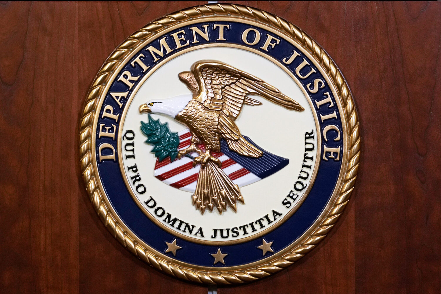 FILE - The seal of the Dept of Justice is shown on the podium, Aug. 1, 2023, at an office of the De...