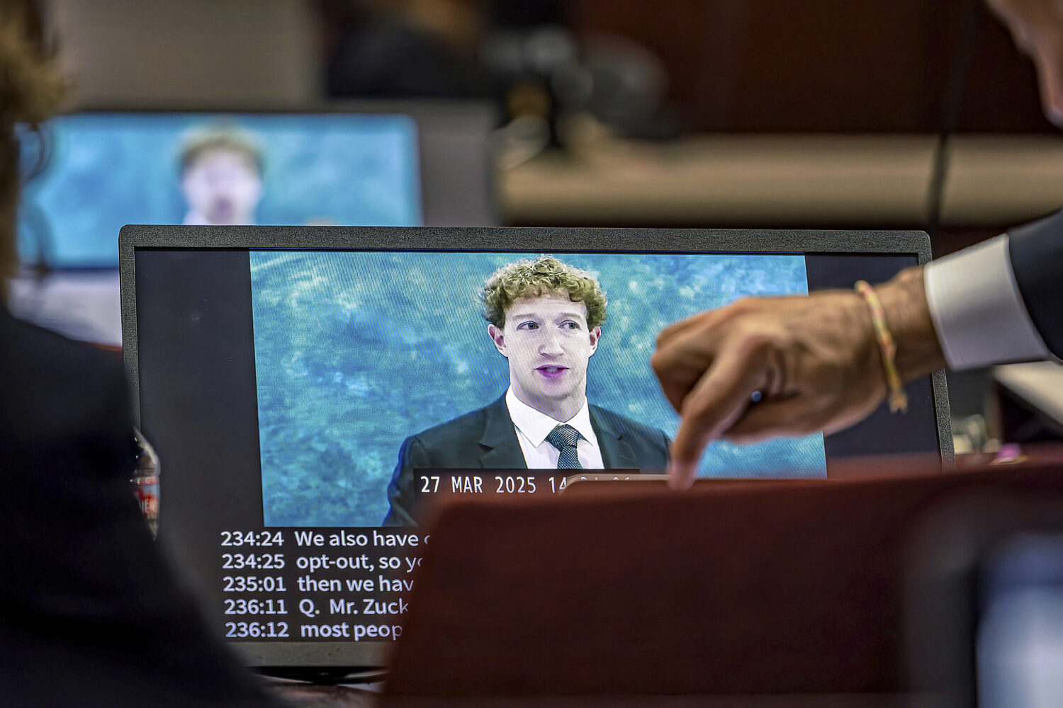 Lawyers for the plaintiff watch on a laptop as a recording of Meta Founder and CEO Mark Zuckerberg'...