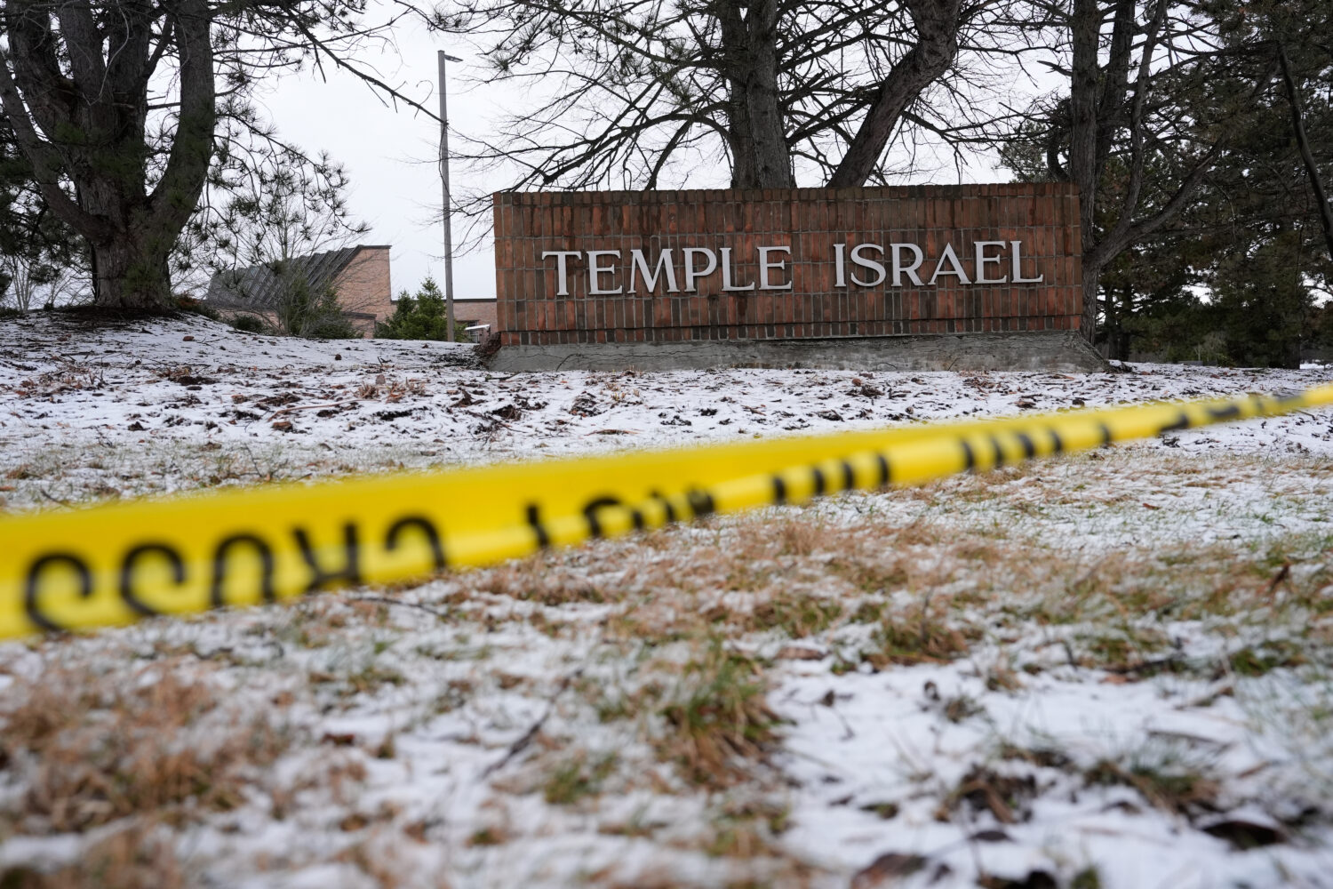 Police tape hangs outside the Temple Israel synagogue Friday, March 13, 2026, in West Bloomfield To...